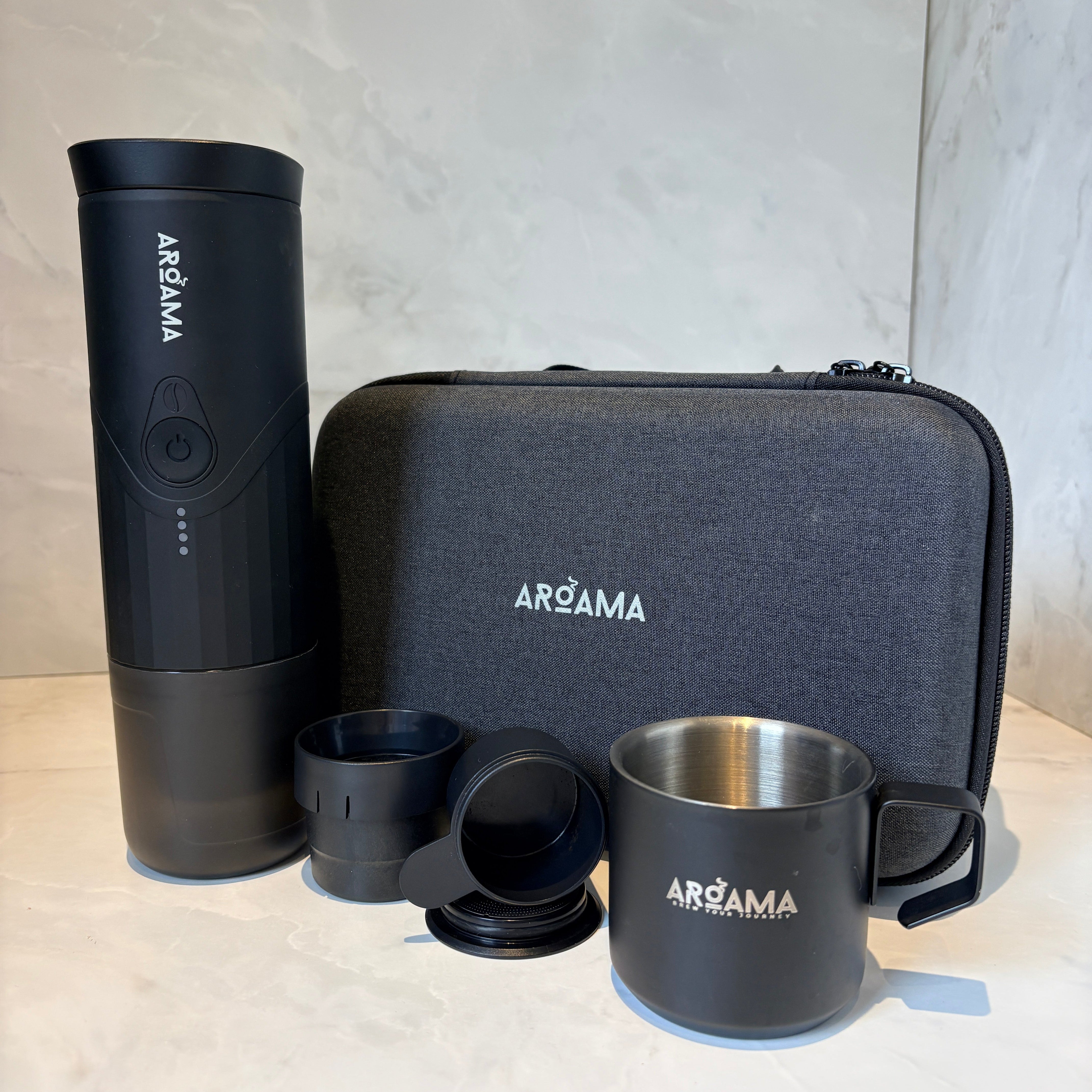 Product shot of espresso machine and carry case with cup
