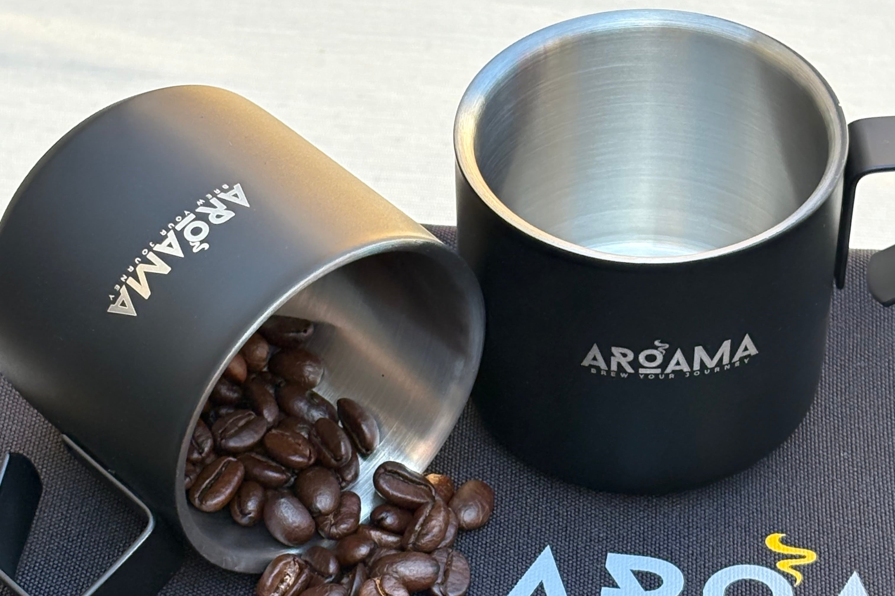 Black coffee cups with coffee beans on a branded mat