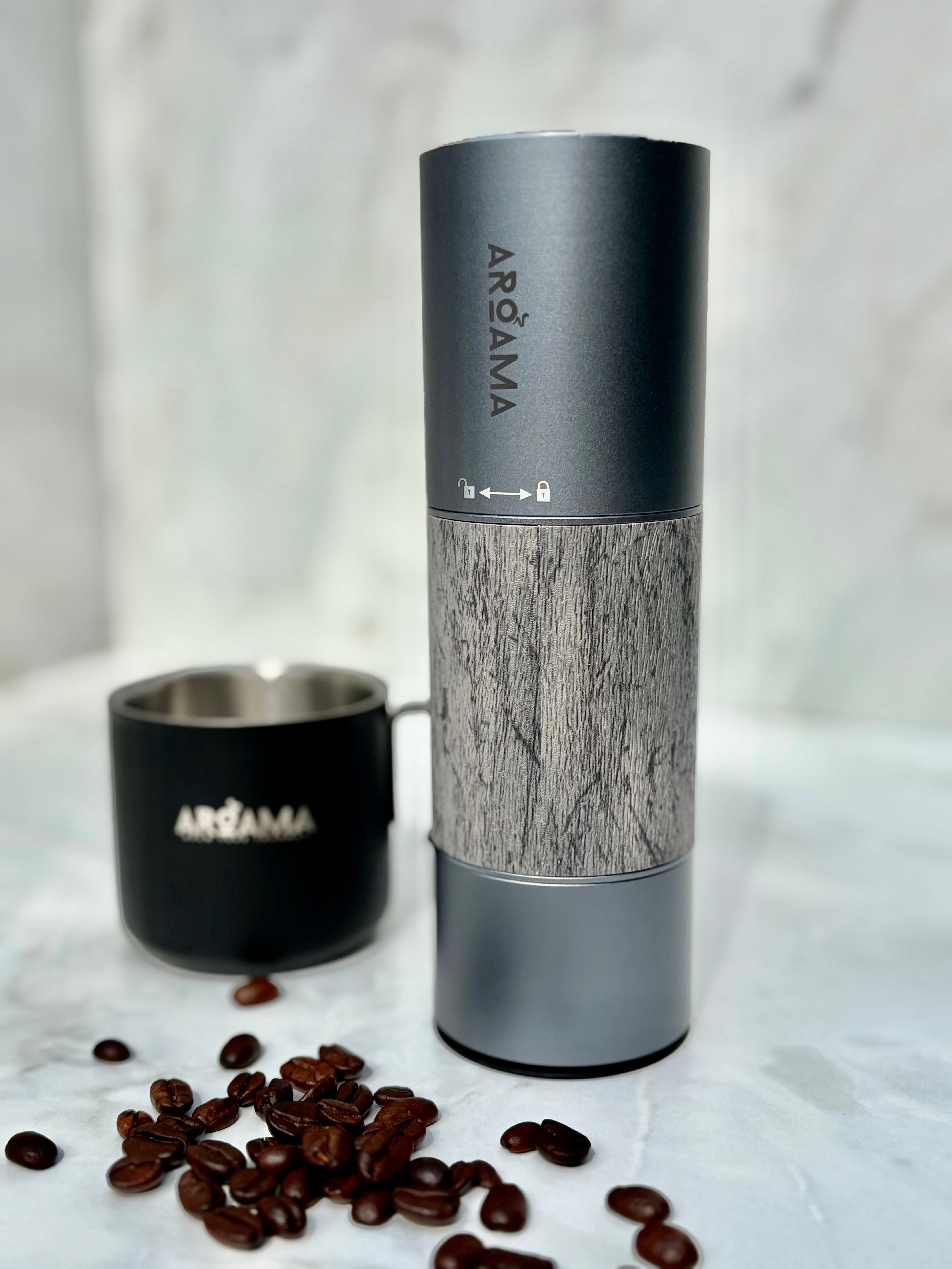 Coffee grinder with wooden pattern and visible brand name on a marble surface with coffee beans.
