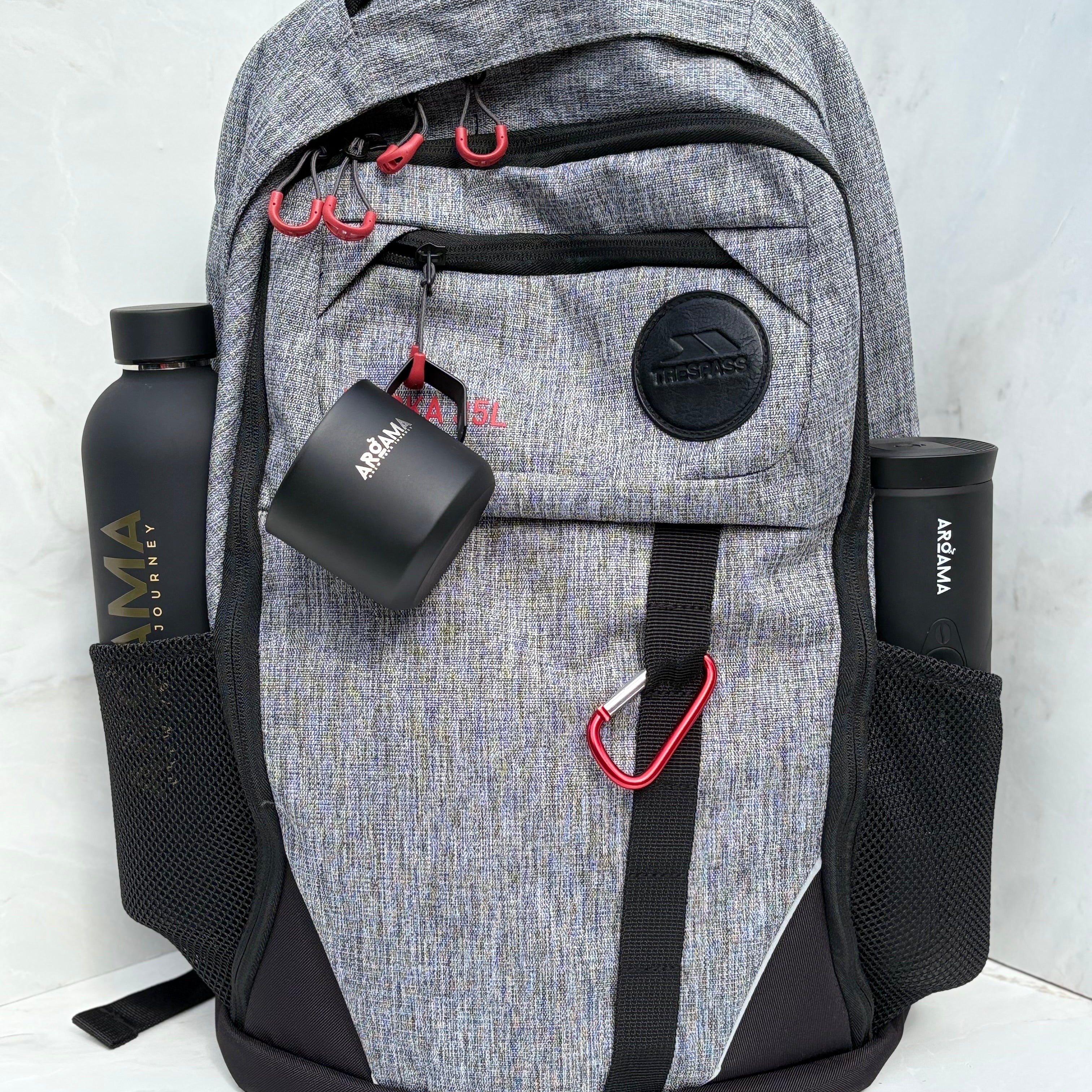 Gray backpack with black accents and water bottles on a white background