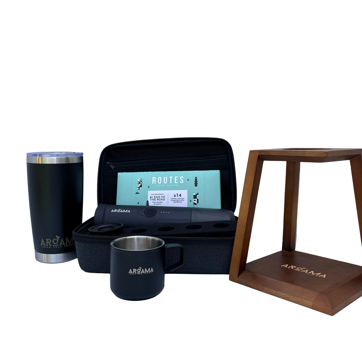 A set of ARoAMA-branded travel accessories arranged on a white marble surface against a matching marble wall, including a black insulated tumbler with gold lettering, a black mug with a silver interior and AROAMA logo, an open black carrying case with a mint green ROUTES card, and a wooden display stand with gold lettering.