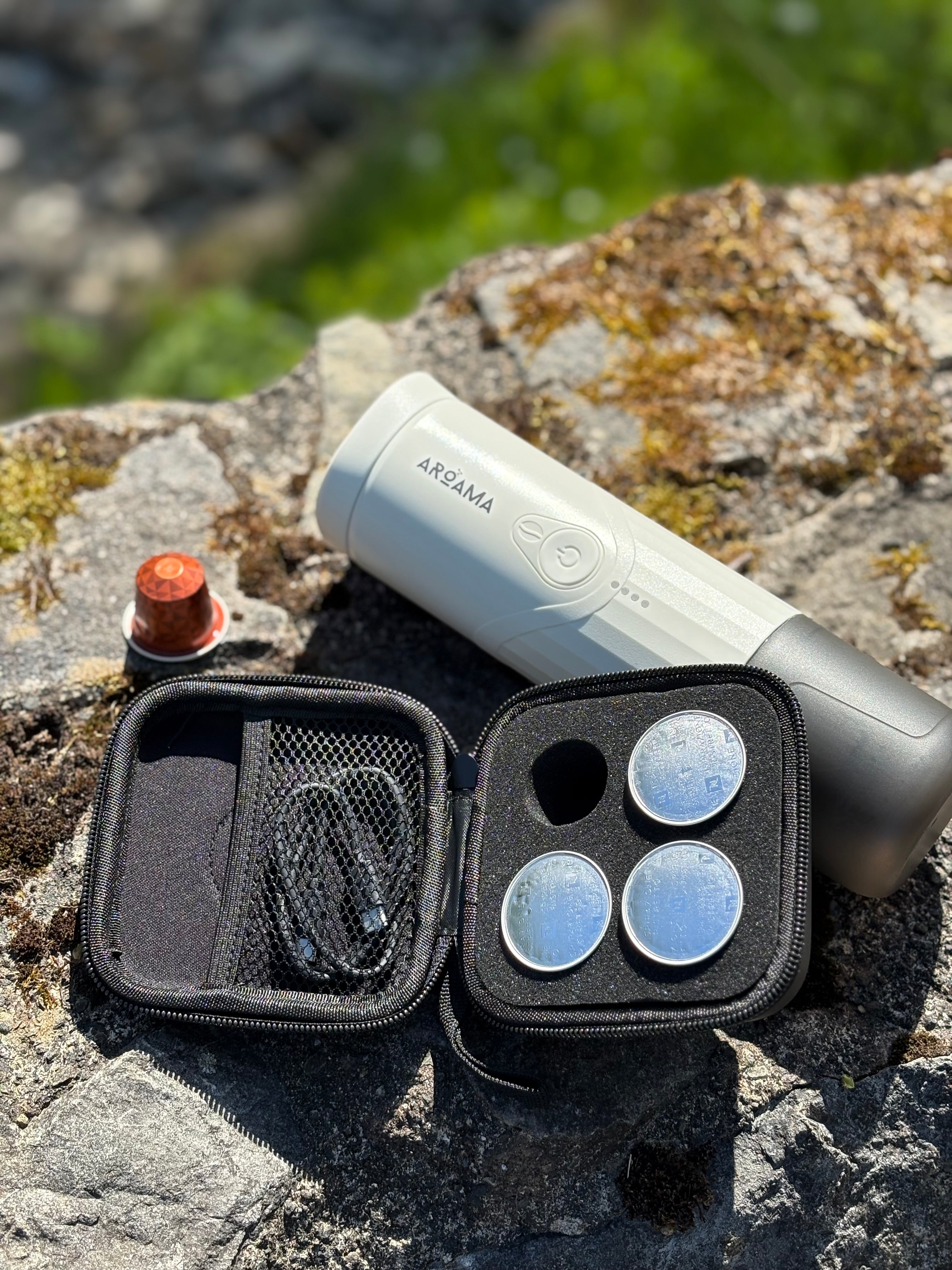Aroama travel case with components on a stone surface