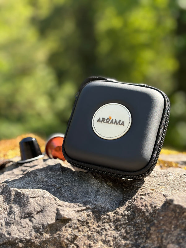 Black carrying case with a logo on a rock outdoors